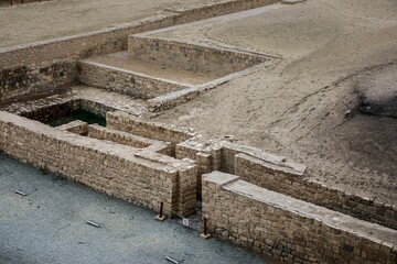 Ancient stone ruins in a desert landscape.