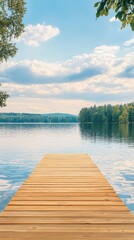 Naklejka premium A serene wooden dock extends into a calm lake, reflecting soft clouds and surrounded by lush greenery under a blue sky.