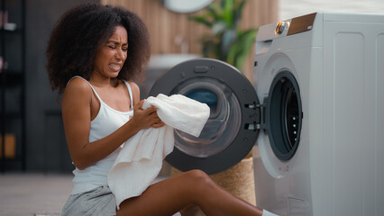 African American female woman girl ethnic lady housewife homeowner housework at floor open washing...