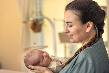 Fototapeta premium A young mother with a newborn baby. Newborn baby.