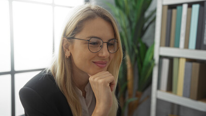 Woman smiling in office with bookshelves in background portrays a professional and serene atmosphere, ideal for concepts of work, balance, and modern lifestyle