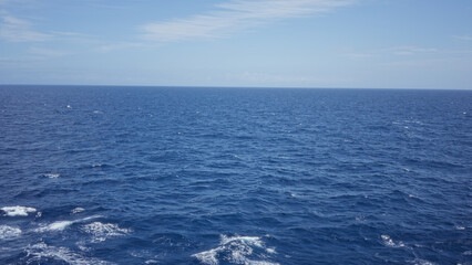 Expansive ocean view under clear sky with gentle waves creating a serene and peaceful outdoor marine seascape in daylight inspiring tranquility and vastness.