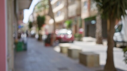 Blurred city street scene with colorful buildings and parked cars creating a bokeh effect.