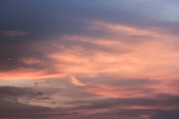 A breathtaking sunset paints the sky with vibrant hues of pink, orange, and purple. Wispy clouds drift across the canvas, creating a mesmerizing spectacle.