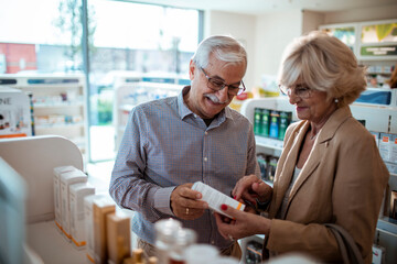Senior couple browsing shelves at a pharmacy drug store
