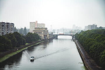 The boat sails along the river canal