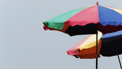 Closeup of colorful umbrellas installed at the beach at Kovalam, Kerala, India