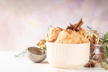 Portioned bowl with Christmas Eggnog ice cream scoops with cinnamon and spices, cold sweet gelato dessert for festive snack