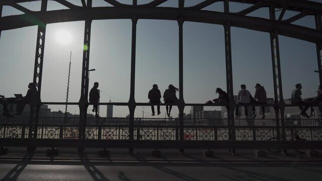 Munich, Germany Hackerbrucke. People relax sitting on bridge near central bus station in munchen and enjoy drinks and sunny weather. Popular meeting place for young people in Munchen. 