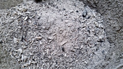 A close-up of cool, grey ash and charcoal