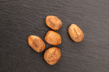 Hazelnuts   on a slate stone, close-up, top view.