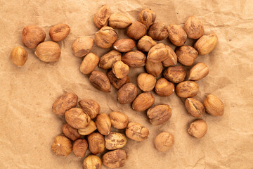 Hazelnuts  on kraft paper, close-up, top view.