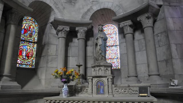 Beautiful interior of a historic chapel featuring stained glass windows and a stone altar with a statue, Eglise Saint-Etienne, Nevers, Ni&egrave;vre, Burgundy, France