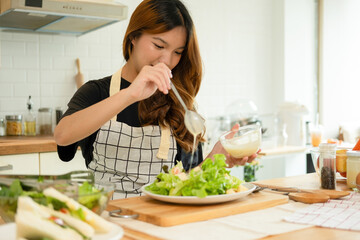 A woman enjoy making salad in the kitchen