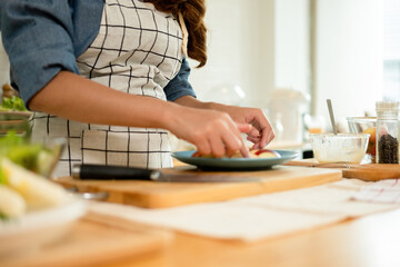 A woman plating her healthy fruit
