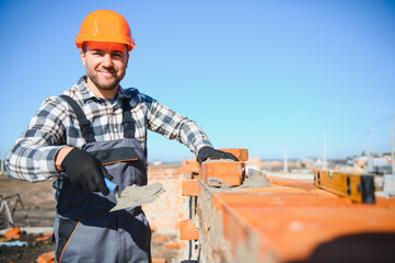 Construction worker in uniform and safety equipment have job on building