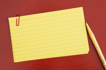 Blank index cards with paperclip and pen on a desk