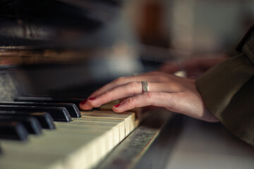 Female hands on piano close-up. Female hands playing the piano.
