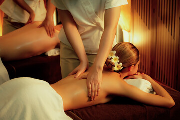Caucasian couple customer enjoying relaxing anti-stress spa massage and pampering with beauty skin...