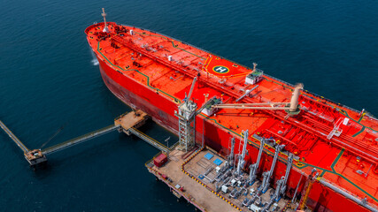 Aerial view oil tanker ship oil depot terminal storage petroleum petrochemical refinery product,...