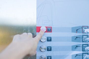 Close-up of woman's hand pressing button on automatic teller machine.  Car washing machine. 