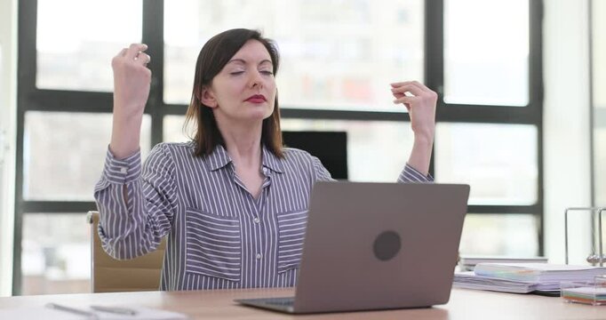 Manager woman practicing meditation at office desk in office