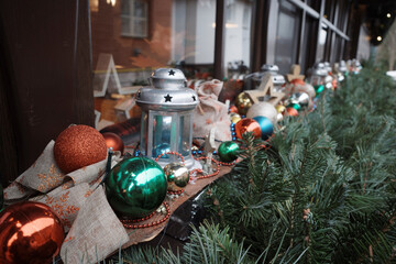 Festive Christmas Window Display with Ornaments and Lanterns