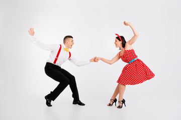Full size portrait of two young rock and roll dancers hold hands chill isolated on white color...