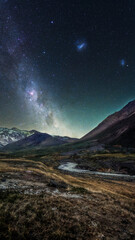 Panoramic Milky Way Arch Over Mountain Range.

An awe-inspiring panoramic photograph capturing the Milky Way arching gracefully over a remote mountain range.