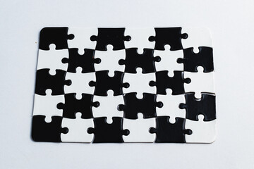 Black and white puzzle, teamwork challenge concept