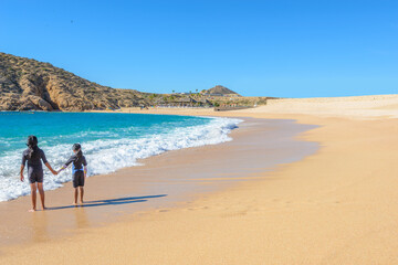 Santa Maria Beach, Cabo San Lucas, Mexico. Different stages of the fantastic ocean waves. Rocky and sandy beach.