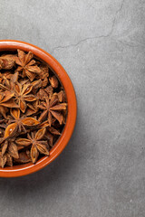 A clay bowl full of Anis on a kitchen countertop in a zenithal photograph