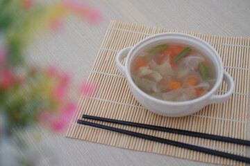 A bowl of fresh soup on a table