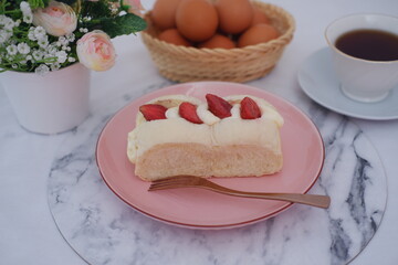 Strawberry cheese cake with cup of coffee on a table.