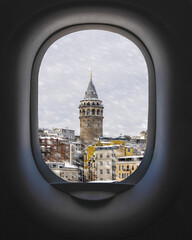 View from airplane window of Istanbul Galata Tower in winter. Concept of travel and air transportation.