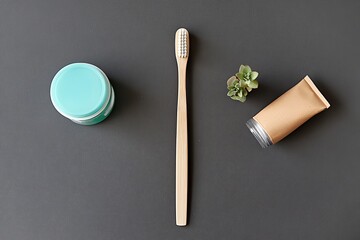 Top-Down View Bamboo Toothbrush, Teal Jar, Brown Tube, Succulent on Dark Surface, Zero Waste Bathroom Concept Zero waste, sustainable, eco-friendly