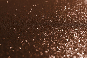 Mocha Mousse, brown sparkling glitter bokeh background, abstract defocused texture. Holiday lights.