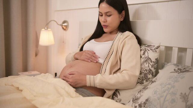 Pregnant woman talking to baby in belly to stimulate a baby's development