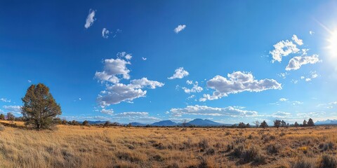 A clear blue sky on a sunny day with a few scattered clouds, providing a peaceful and serene atmosphere.
