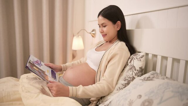 Pregnant woman reading fairy tales to baby