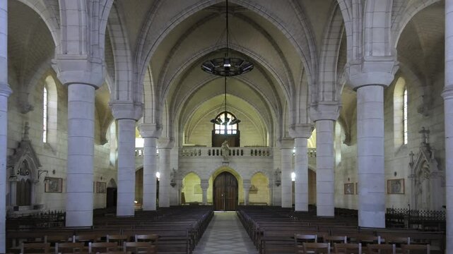 Architectural beauty of a grand cathedral interior featuring tall arches and wooden pews, Eglise de Saint Maurice, Ch&acirc;tillon-sur-Loire, Centre, France