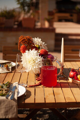 a set table with flowers, fruits and candles for a festive event in nature 