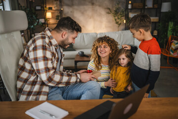 Mum and children surprise dad with gift while he work from home