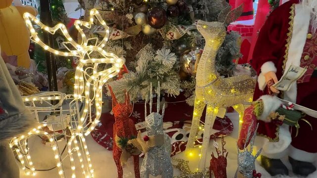 4k footage of interactive sparkling twinkle lights at christmas decoration, in many forms. Reindeeer shapes, deer, santa claus, snowman, and nutcracker. Led icicle twinkle lights for christmas.