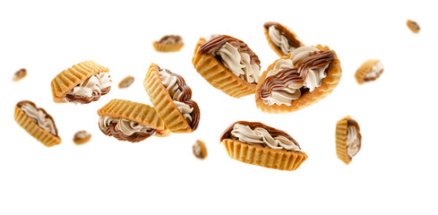 Two types of cream filled tartlets fly and levitate in space. Isolated on white