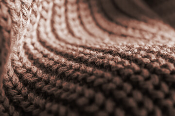 Knitted texture of a pink sweater or scarf close-up.