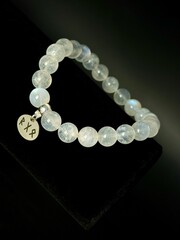 bracelet made of expensive natural stone with silver inserts and a pendant with runes