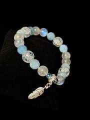 bracelet made of expensive natural stone with silver inserts and a pendant with runes