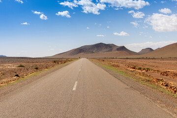 Long road through the Moroccan desert along the Atlas Mountains