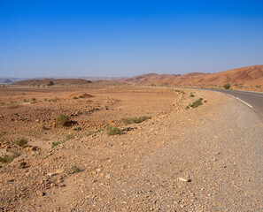 Long road through the Moroccan desert along the Atlas Mountains